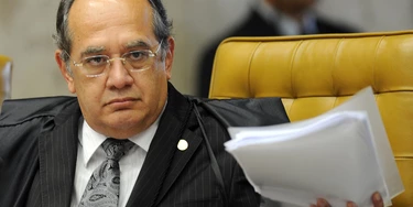 Brazilian Supreme Court Minister Gilmar Mendes during the session on the case of Italian Cesare Battisti in Brasilia, on June 8, 2011.Thirty years after fleeing Italy, former far-left militant Cesare Battisti will likely find out Wednesday whether he will be extradited to his native country on murder charges or remain in Brazil, perhaps as a free man. Italy wants Brazil to extradite Battisti, convicted in an Italian court in 1993 for the murders of four people in the 1970s when he was a member of the radical Armed Proletarians for Communism (PAC) group. AFP PHOTO/Evaristo SA (Photo credit should read EVARISTO SA/AFP/Getty Images)