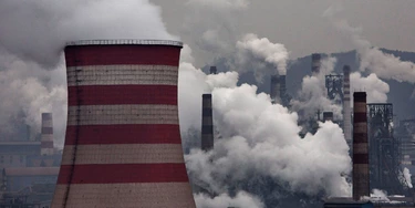 HEBEI, CHINA - NOVEMBER 19:  Smoke billows from smokestacks and a coal fired generator at a steel factory on November 19, 2015 in the industrial province of Hebei, China. China's government has set 2030 as a deadline for the country to reach its peak for emissions of carbon dioxide, what scientists and environmentalists cite as the primary cause of climate change. At an upcoming conference in Paris, the governments of 196 countries will meet to set targets on reducing carbon emissions in an attempt to forge a new global agreement on climate change.  (Photo by Kevin Frayer/Getty Images)