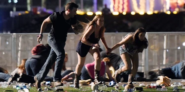 LAS VEGAS, NV - OCTOBER 01:  People run from the Route 91 Harvest country music festival after apparent gun fire was hear on October 1, 2017 in Las Vegas, Nevada. A gunman has opened fire on a music festival in Las Vegas, leaving at least 20 people dead and more than 100 injured. Police have confirmed that one suspect has been shot. The investigation is ongoing. (Photo by David Becker/Getty Images)