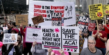 Protesters gather across the Chicago River from Trump Tower to rally against the repeal of the Affordable Care Act Friday, March 24, 2017, in Chicago. Earlier, President Donald Trump and GOP leaders yanked their bill to repeal "Obamacare" off the House floor Friday when it became clear it would fail badly. (AP Photo/Charles Rex Arbogast)