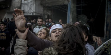 2757513 12/12/2015 Residents and relatives of the victims on the site of the terrorist act in downtown Homs. On December 12, terrorists staged a deadly car bomb attack near the Al-Ahli hospital. Valeriy Melnikov/Sputnik via AP