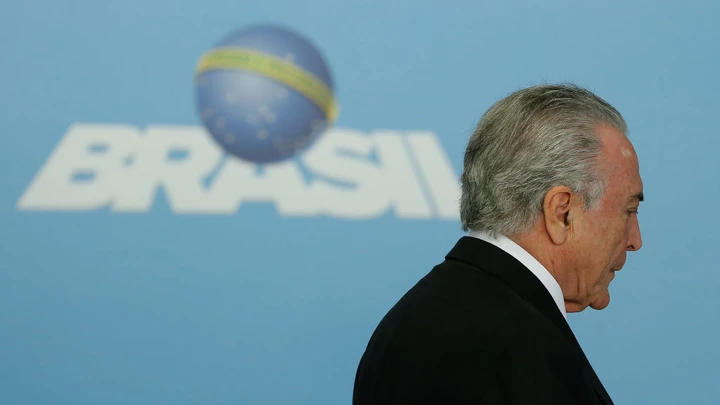 Brazil's President Michel Temer arrives for a ceremony to announce the airports' franchise programme, at the Planalto Palace in Brasilia, Brazil on July 27, 2017. 
Brazilian President Michel Temer's popularity fell from 10 percent in March to a meager 5 percent, according to a poll released on Thursday in the prelude to the voting at the Chamber of Deputies to decide if a corruption report against the conservative leader advances to the supreme court. / AFP PHOTO / Sergio LIMA        (Photo credit should read SERGIO LIMA/AFP/Getty Images)