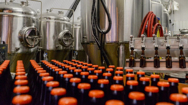 LONDON, ENGLAND - DECEMBER 08:  A batch of bottled Megawatt Double I.P.A. lies in front of the fermenting vessels at inner city craft beer makers Brixton Brewery on December 8, 2015 in London, England. Located in three railway arches on Brixton Station Road, the Brixton Brewery was founded in 2013 by two local couples and hand craft nine varieties of beer in small batches. The brewery has expanded into a third railway arch at the end of 2015 as the business grows.  (Photo by Chris Ratcliffe/Getty Images)