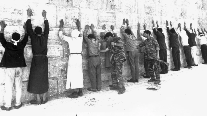 File - In this June 8, 1967 file photo, Israeli soldiers search Jordanian prisoners during mopping up operations in the old city of Jerusalem, as the city came under Jewish control during the Six-Day War. It may well be remembered as a pyrrhic victory for Israel: a six-day war in which it vanquished several Arab armies, only to be saddled with a 50-year fight with the Palestinians for the Holy Land. A half century after the watershed 1967 Mideast war, many in Israel think the lighting victory planted the seeds of doom.  (AP Photo)