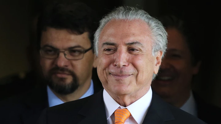 Brazil’s Vice President Michel Temer talks with journalists as he leaves his office at Planalto presidential palace in Brasilia, Brazil, Wednesday, Dec. 9, 2015. A private letter from Temer to President Dilma Rousseff shook the country on Tuesday, revealing differences between them at a time when the president is facing possible impeachment. The letter was published in Brazil's newspaper O Globo. (AP Photo/Eraldo Peres)