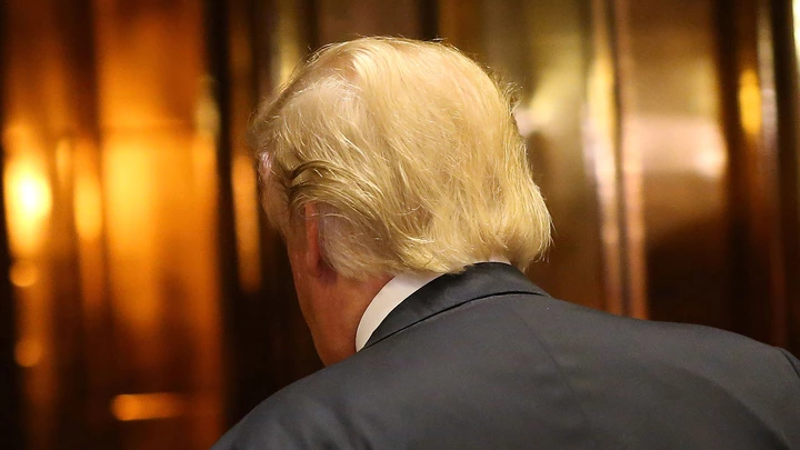 NEW YORK, NY - DECEMBER 06:  U.S. President-Elect Donald Trump walks back into an elevator after emerging for a minute to speak to the media at Trump Tower following meetings on December 6, 2016 in New York City. Potential members of President-elect Donald Trump's cabinet have been meeting with him and his transition team of the last few weeks.  (Photo by Spencer Platt/Getty Images)