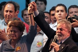 Brazil's Workers Party presidential candidate Dilma Rousseff, left, reacts as Brazil's President Luiz Inacio Lula da Silva speaks to supporters during a campaign rally in Goiania, Brazil, Tuesday, Oct. 19, 2010. Rousseff will face Jose Serra, presidential candidate of the Brazilian Social Democratic Party, PSDB, in an election runoff Oct. 31. (AP Photo/Eraldo  Peres)