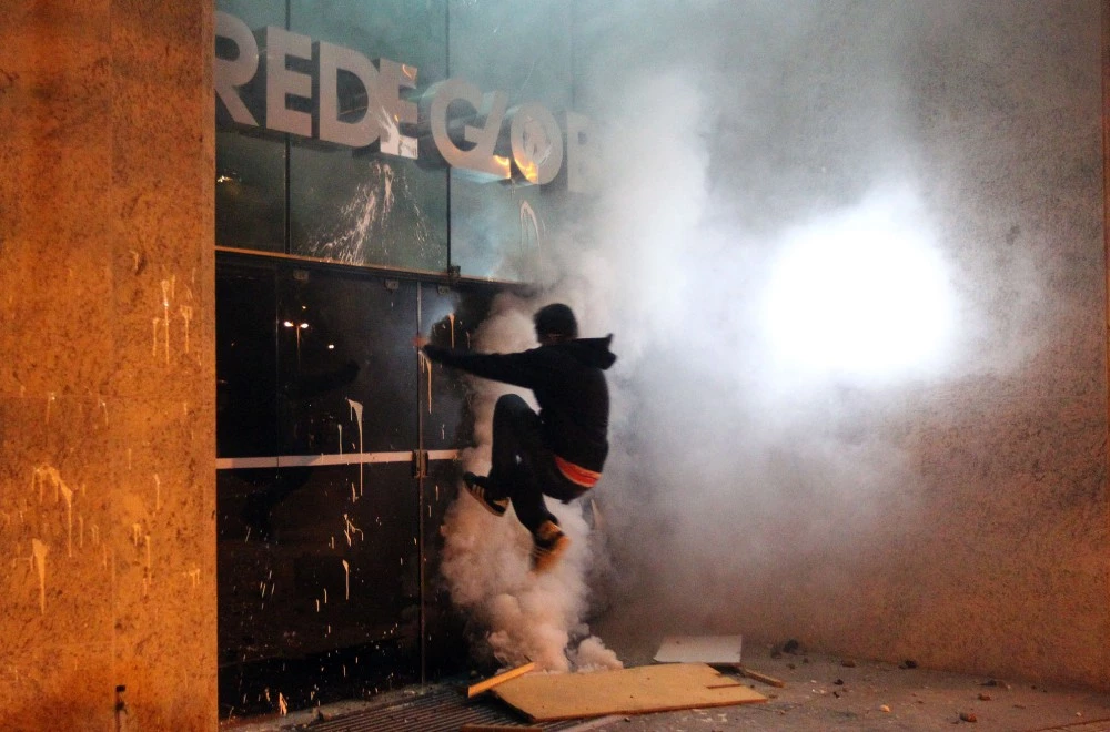 Protesters destroy a building entrance channel TV, Rede Globo, in Leblon, Rio de Janeiro, southeastern Brazil, this morning, July 18, 2013. The protest was against the governor of Rio de Janeiro, Sérgio Cabral. Photo: MARCOS DE PAULA/ESTADAO CONTEUDO. (Agencia Estado via AP Images)