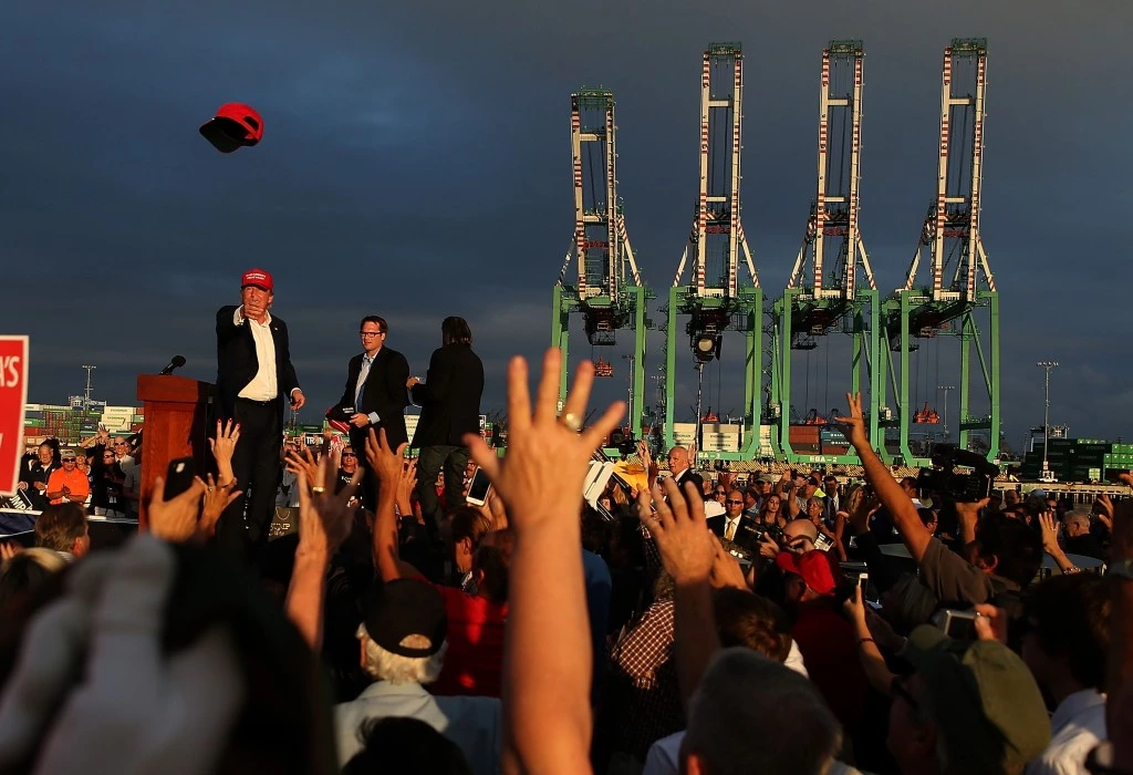 LOS ANGELES, CA - SEPTEMBER 15:  Republican presidential candidate Donald Trump (L) throws a hat to supporters during a campaign rally aboard the USS Iowa on September 15, 2015 in Los Angeles, California. Donald Trump is campaigning in Los Angeles a day ahead of the CNN GOP debate that will be broadcast from the Ronald Reagan Presidential Library in Simi Valley.  (Photo by Justin Sullivan/Getty Images)