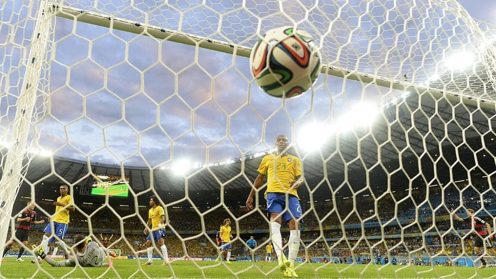 Brazil's goalkeeper Julio Cesar (L bottom) concedes a goal during the semi-final football match between Brazil and Germany at The Mineirao Stadium in Belo Horizonte during the 2014 FIFA World Cup on July 8, 2014. Germany won 7-1.  AFP PHOTO / ADRIAN DENNIS        (Photo credit should read ADRIAN DENNIS/AFP/Getty Images)
