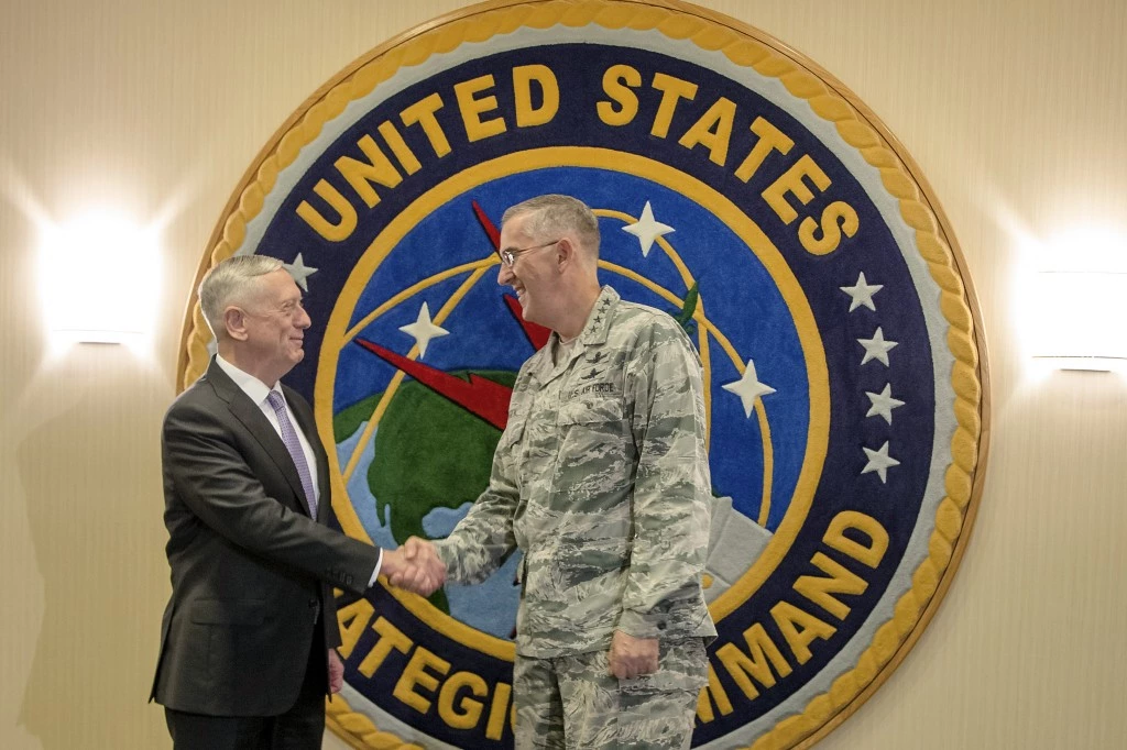 Secretary of Defense Jim Mattis, left, poses for a handshake at Offutt Air Force Base with Gen. John E. Hyten, the head of Strategic Command, in Bellevue, Neb., Thursday, Sept. 14, 2017. Mattis will be receiving classified briefings at Strategic Command, which will help him in his "nuclear posture review," a top-to-bottom reassessment of U.S. nuclear weapons policy. (AP Photo/Nati Harnik)