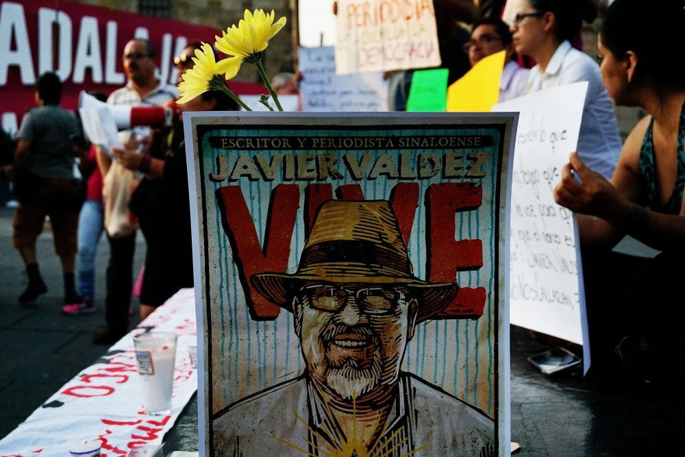 Journalists hold signs condemning violence against journalists while protesting the recent murder of the of Mexican journalist Javier Valdez on May 16, 2017 in Guadalajara. Mexico ranks third in the world for the number of journalists killed, after Syria and Afghanistan, according to the media rights group Reporters Without Borders (RSF) / AFP PHOTO / Hector Guerrero (Photo credit should read HECTOR GUERRERO/AFP/Getty Images)