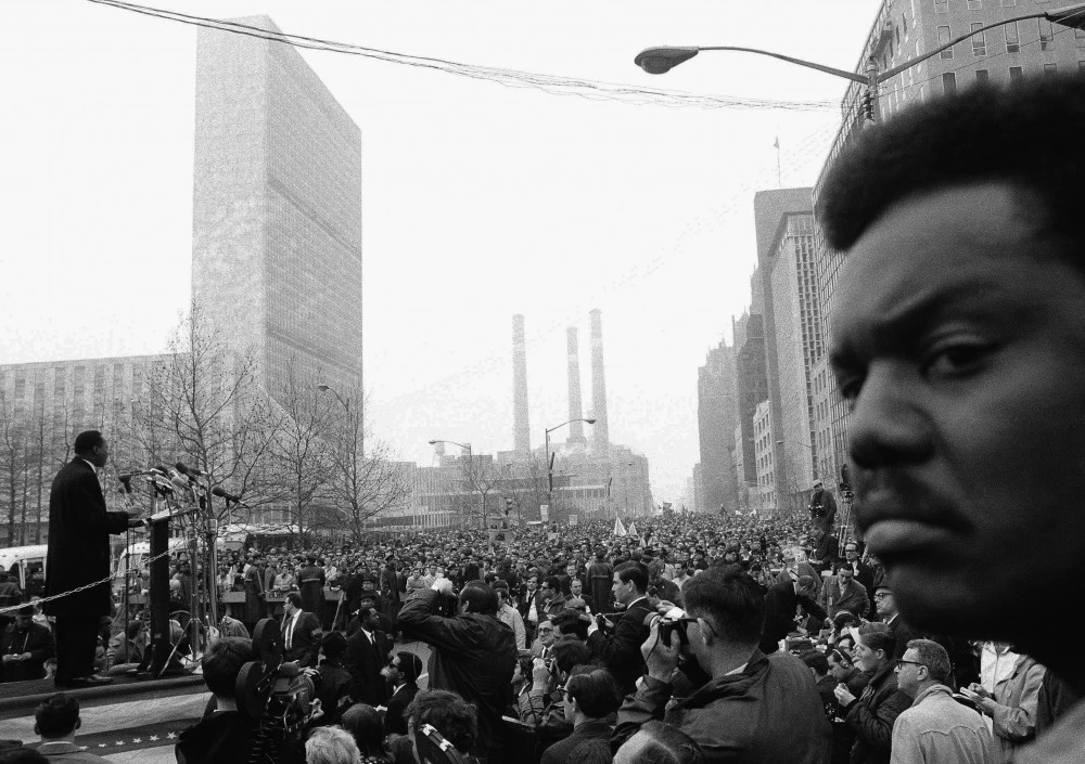 Dr. Martin Luther King on platform talks to thousands of demonstrators on United Nations Plaza on April 15. 1967 in New York City.     The demonstrators were protesting  the war in Vietnam.   Dr. King was one of the Leaders of the March called the "Spring Mobilization against the war in Vietnam". (AP Photo)