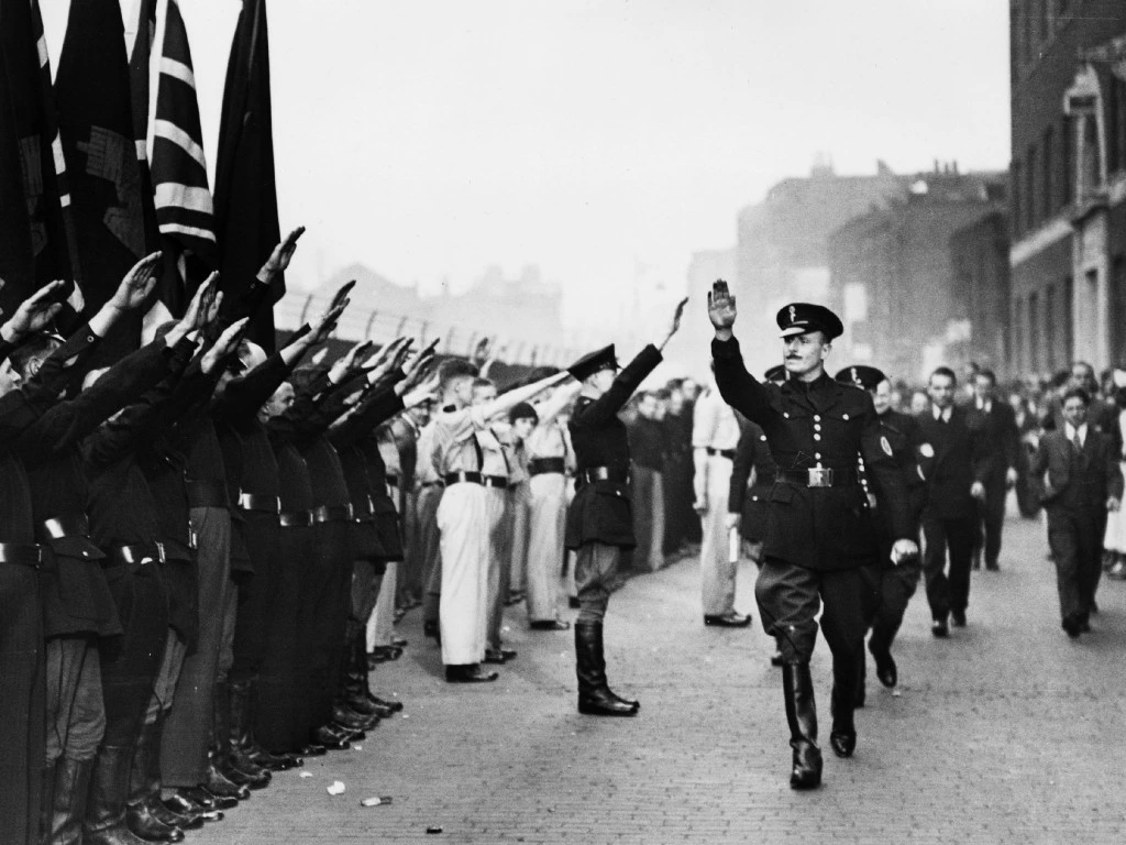 4th October 1936:  British politician Sir Oswald Ernald Mosley (1896 - 1980) inspects members of his British Union of Fascists in Royal Mint Street, London. Their presence sparked a riot which became known as the Battle of Cable Street. (Photo by Central Press/Getty Images)