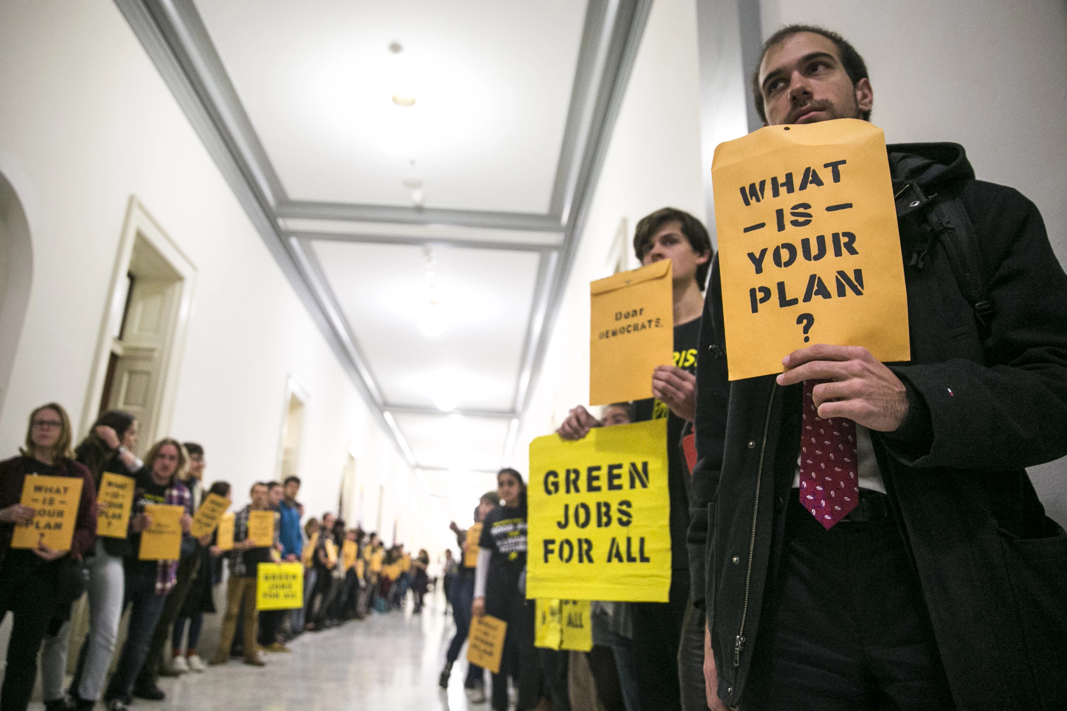 Protesters from the Sunrise Movement gather outside the offices of House Minority Leader Nancy Pelosi (D-Calif.) on Capitol Hill, in Washington, Nov. 13, 2018. Alexandria Ocasio-Cortez, congresswoman-elect from New York, also made a visit to the protest. (Sarah Silbiger/The New York Times)