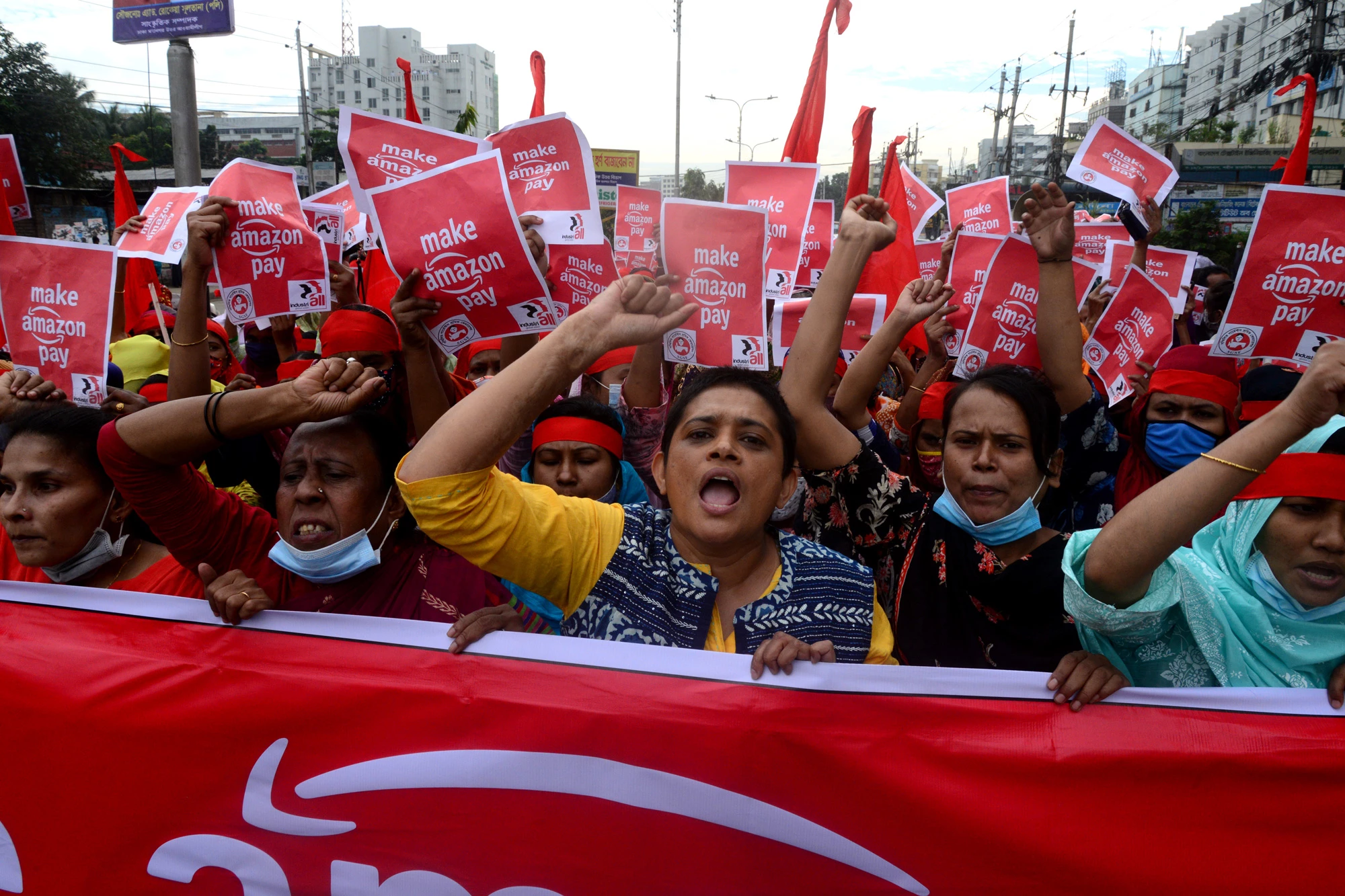 Activists of Sammilito Garments Sramik Federation (Combined Garments Workers Federation) stage a protest procession against the world's leading digital retailer Amazon.com demanding fair wages and union rights for all Amazon supply chain workers in Dhaka, Bangladesh, on November 27, 2020 (Photo by Mamunur Rashid/NurPhoto via Getty Images)