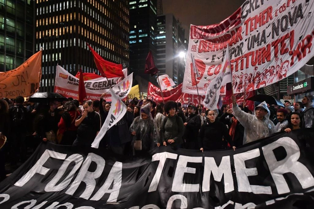 Demonstrators protest against Brazilian President Michel Temer along Paulista Avenue in Sao Paulo, Brazil on May 18 2017. Temer faced growing pressure to resign Thursday after the Supreme Court gave the green light to an investigation over allegations that he authorized paying hush money to already jailed Eduardo Cunha, the disgraced former speaker of the lower house of Congress. / AFP PHOTO / NELSON ALMEIDA (Photo credit should read NELSON ALMEIDA/AFP/Getty Images)