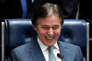 Brazilian Senate President Eunicio Oliveira gestures during the vote of the labour reform at the National Congress in Brasilia, on July 11, 2017. Oliveira suspended the session and the lights of the plenary were turned off to put an end to a protest, seven hours later the session resumed and the law was passed with 50 votes in favour and 26 against. / AFP PHOTO / EVARISTO SA (Photo credit should read EVARISTO SA/AFP/Getty Images)