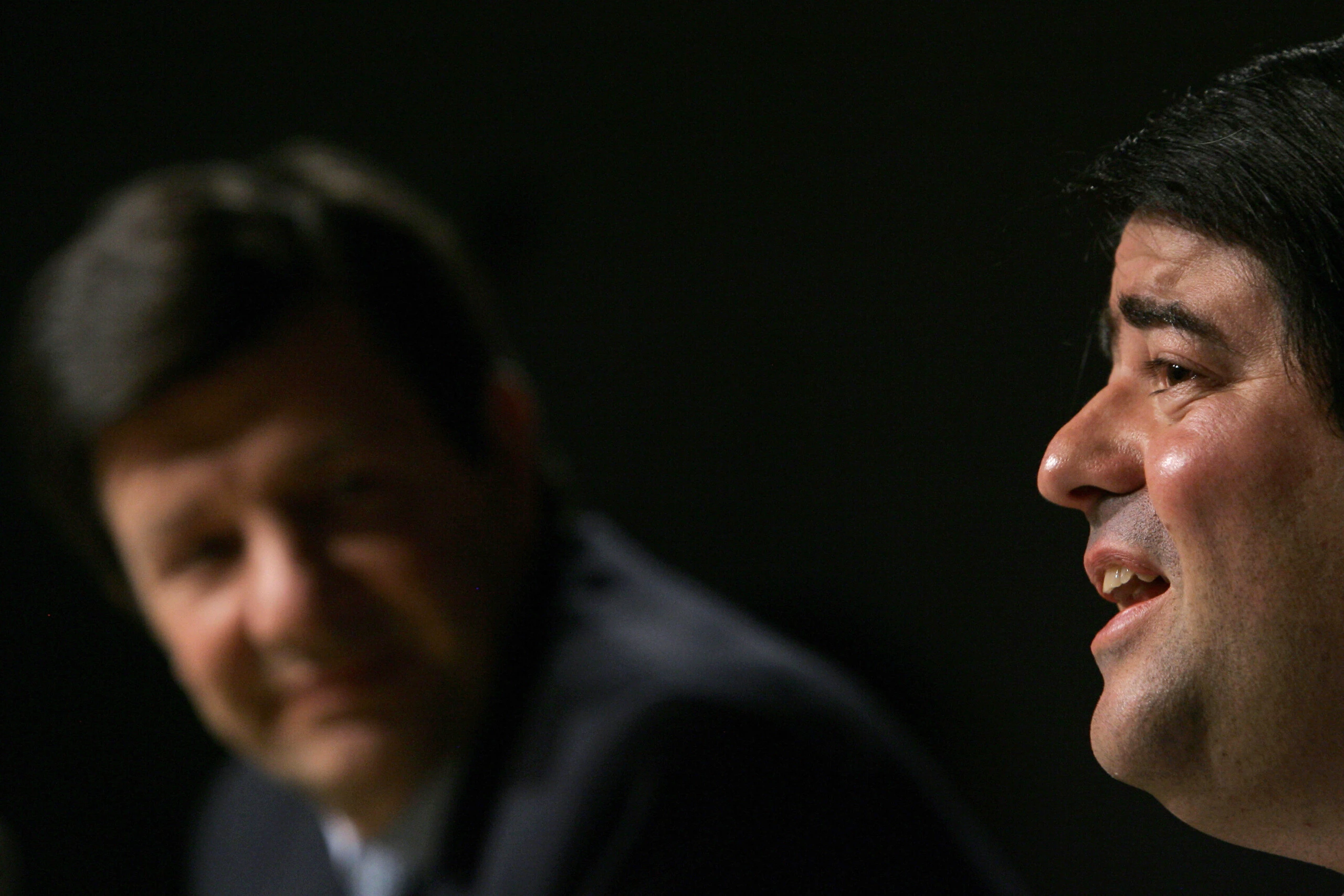 Brazilian bankers Roberto Setubal (L), of Itau, listens to Pedro Moreira Salles, of Unibanco, as he speaks during a press conference announcing the merger of their institutions, in Sao Paulo, Brazil, on November 3, 2008. Brazil's Itau and Unibanco stated they were merging to create the biggest bank in Latin America, with combined assets of more than 260 billion dollars. Itau is currently the second largest private-sector bank in Brazil, and Unibanco is ranked fourth. AFP PHOTO/Mauricio Lima (Photo credit should read MAURICIO LIMA/AFP/Getty Images)