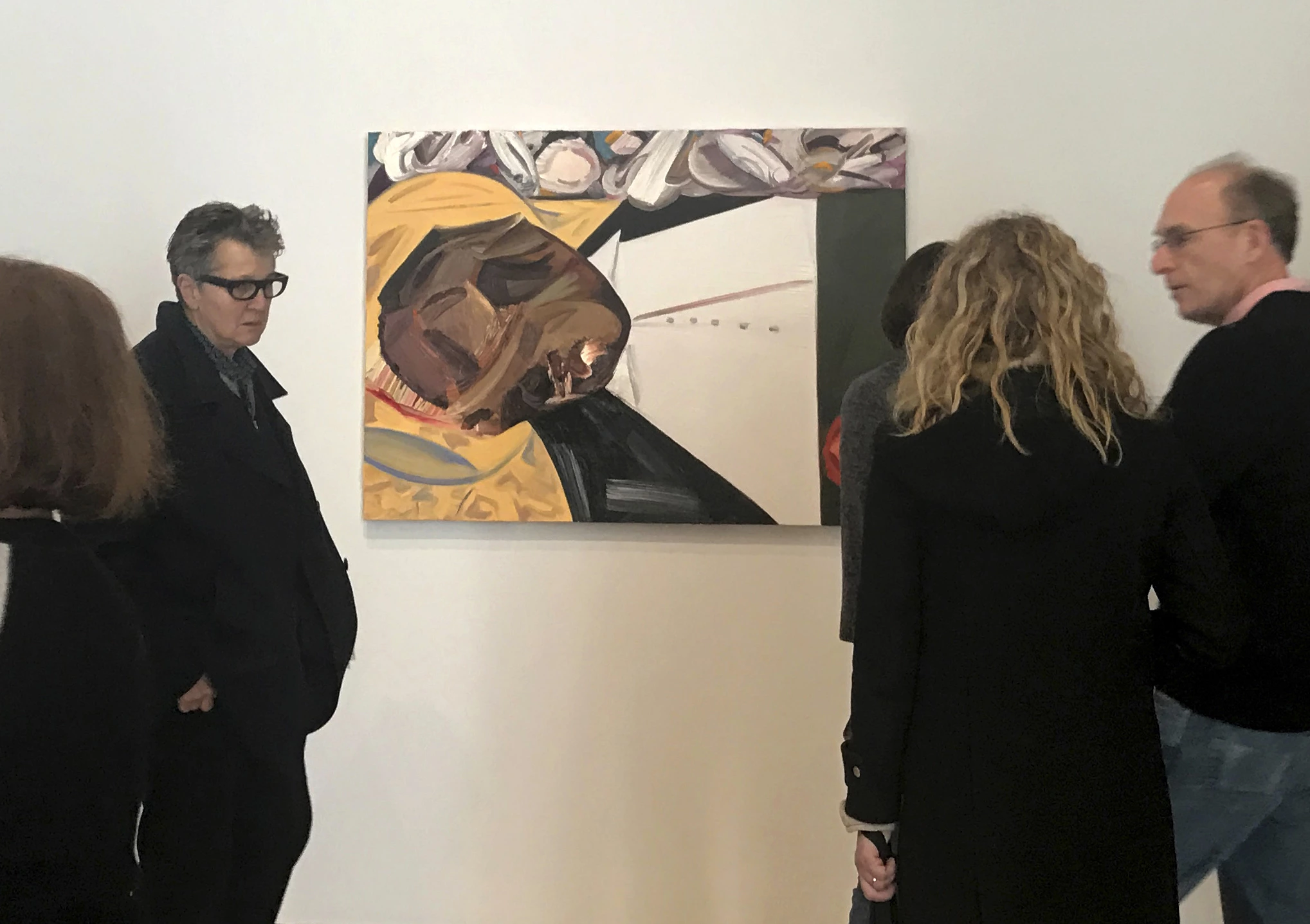 A group of museum-goers examine a painting entitled "Open Casket" by artist Dana Schutz at the Whitney Museum of American Art in New York, Thursday, March 23, 3017. The painting, made with the aid of historical photographs of Emmett Till as he lay in his casket, has left some gravely displeased and triggered outcry. Till was a 14-year-old black teenager when he was killed by white men in 1955 for allegedly whistling at a white woman. (AP Photo/Alina Heineke)