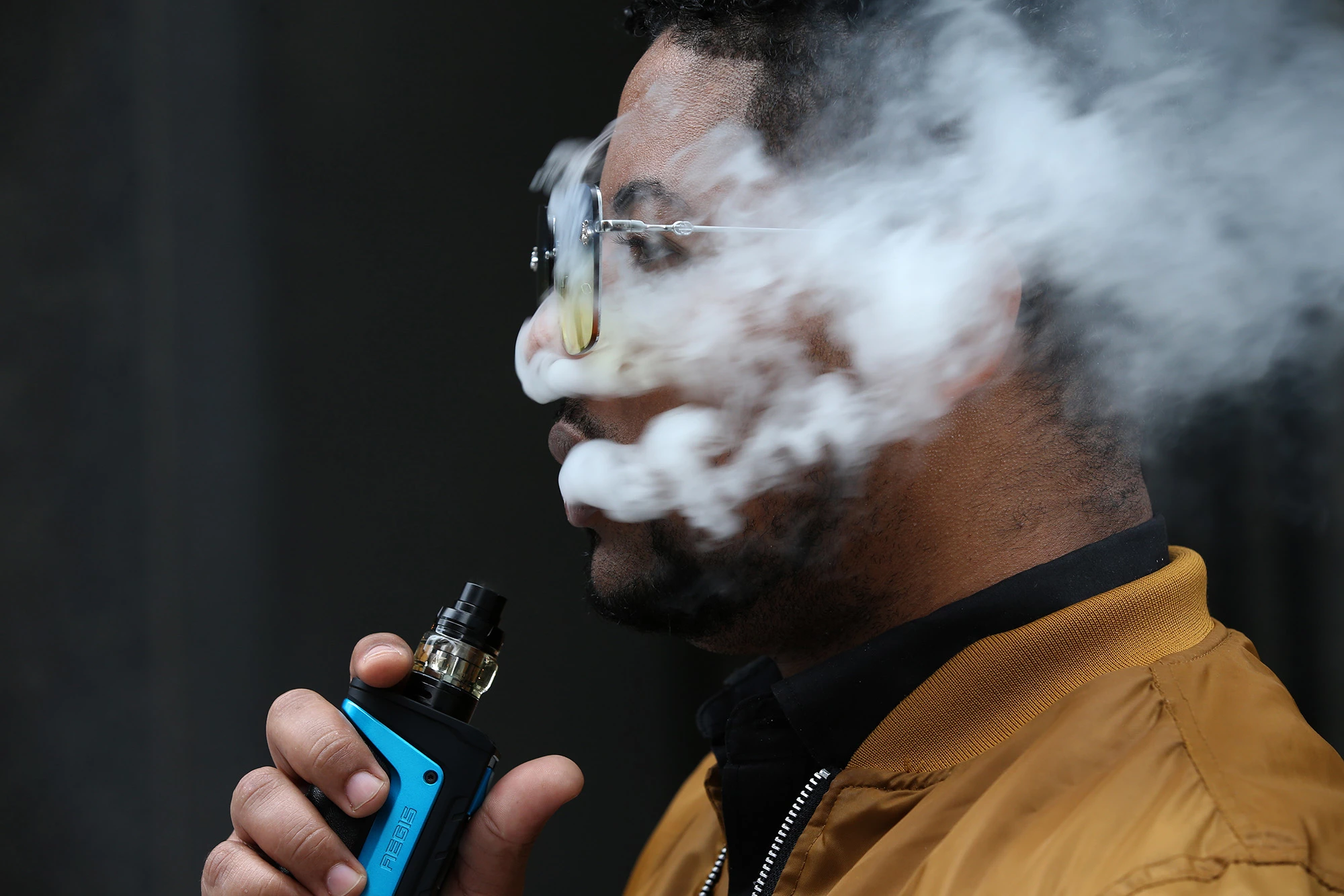 Frankie Paulino, of Chicago, uses his vaping device at Dearborn and Jackson in Chicago, Monday, Sept. 16, 2019. Paulino believes excessive vaping is bad and prefers the mint flavor. (Antonio Perez/Chicago Tribune/Tribune News Service via Getty Images)