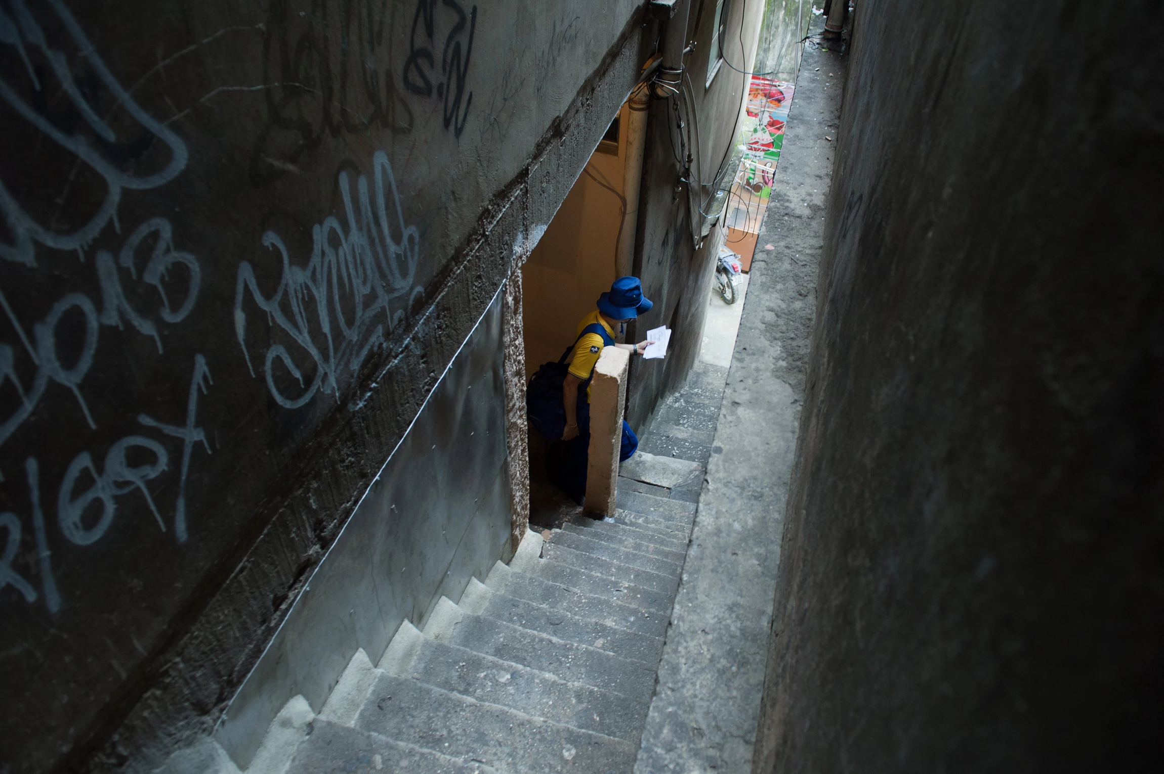 A Brazilian postman delivers letters in Rocinha slum in Rio de Janeiro on October 4, 2013.  AFP PHOTO / CHRISTOPHE SIMON        (Photo credit should read CHRISTOPHE SIMON/AFP via Getty Images)