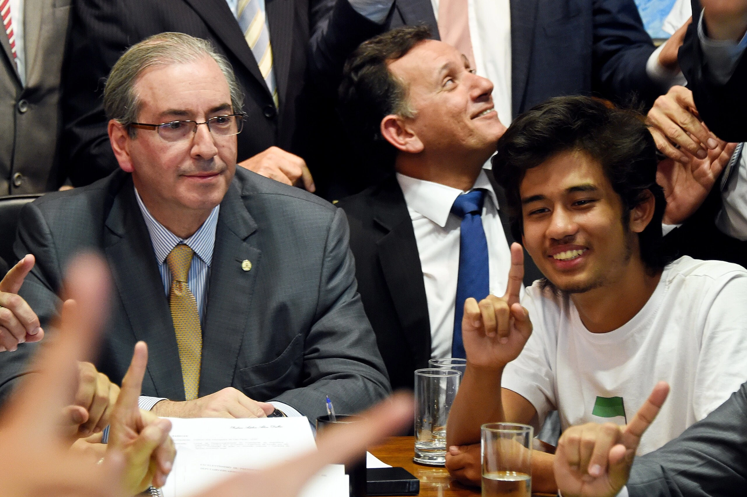 Kim Kataguiri (R), leader of the Free Brazil Movement (MBL), meets with Brazilian Lower House President Eduardo Cunha in Brasilia, Brazil on May 27, 2015. Kataguiri, a 19-year-old college drop out, is the face of MBL, a growing force which seeks to harness some of the energy of the 2013 protest movement which brought more than a million onto the streets. AFP PHOTO/EVARISTO SA        (Photo credit should read EVARISTO SA/AFP/Getty Images)