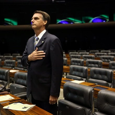 epa04149938 Legislator Jair Bolsonaro, who supports the dictatorship, participates in a session held at Chamber of Legislators in Brasilia, Brazil, 01 April 2014. Brazilian Chamber of Legislators abruptly stoped the session in rejection of the 50 year anniversary of the military coup at the moment that Bolsonaro wanted to start his speech. Members of Parliament jeered at him and turned their backs in way of protest.  EPA/FERNANDO BIZERRA JR. (Newscom TagID: epalive129917.jpg) [Photo via Newscom]