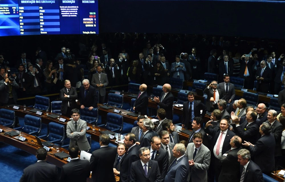 The final score of a Senate vote with an overwhelming 55-22 on suspending Brasilian President Dilma Rousseff and launching an impeachment trial is pictured on a large screen inside the Senate in Brasilia on May 12, 2016.Brazilian President Dilma Rousseff was suspended on May 12 to face impeachment, ceding power to her vice-president-turned-enemy Michel Temer in a political earthquake ending 13 years of leftist rule over Latin America's biggest nation. / AFP / EVARISTO SA (Photo credit should read EVARISTO SA/AFP/Getty Images)