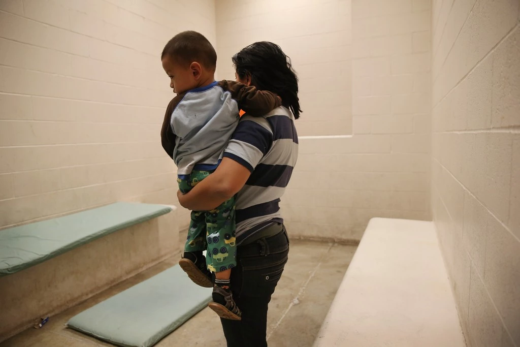 MCALLEN, TX - APRIL 11:  A Honduran mother holds her toddler son at the U.S. Border Patrol detainee processing center on April 11, 2013 in McAllen, Texas. They had been caught by the Border Patrol while crossing illegally from Mexico into Texas. According to the Border Patrol, undocumented immigrant crossings have increased more than 50 percent in Texas' Rio Grande Valley sector in the last year. With more apprehensions, they have struggled to deal with overcrowding while undocumented immigrants are processed for deportation. (Photo by John Moore/Getty Images)