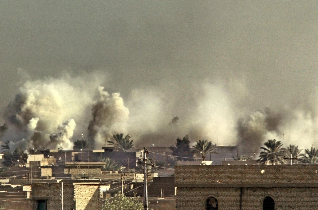 FALLUJAH, IRAQ:  Smoke billows from US targeted areas in the restive Sunni Muslim Iraqi city of Fallujah 11 November 2004, west of Baghdad. US forces aim to control all of Fallujah in two days time despite fierce fighting as they push deeper, an officer said, adding that they already command 75 percent of the rebel Iraqi enclave.   AFP PHOTO/PATRICK BAZ  (Photo credit should read PATRICK BAZ/AFP/Getty Images)