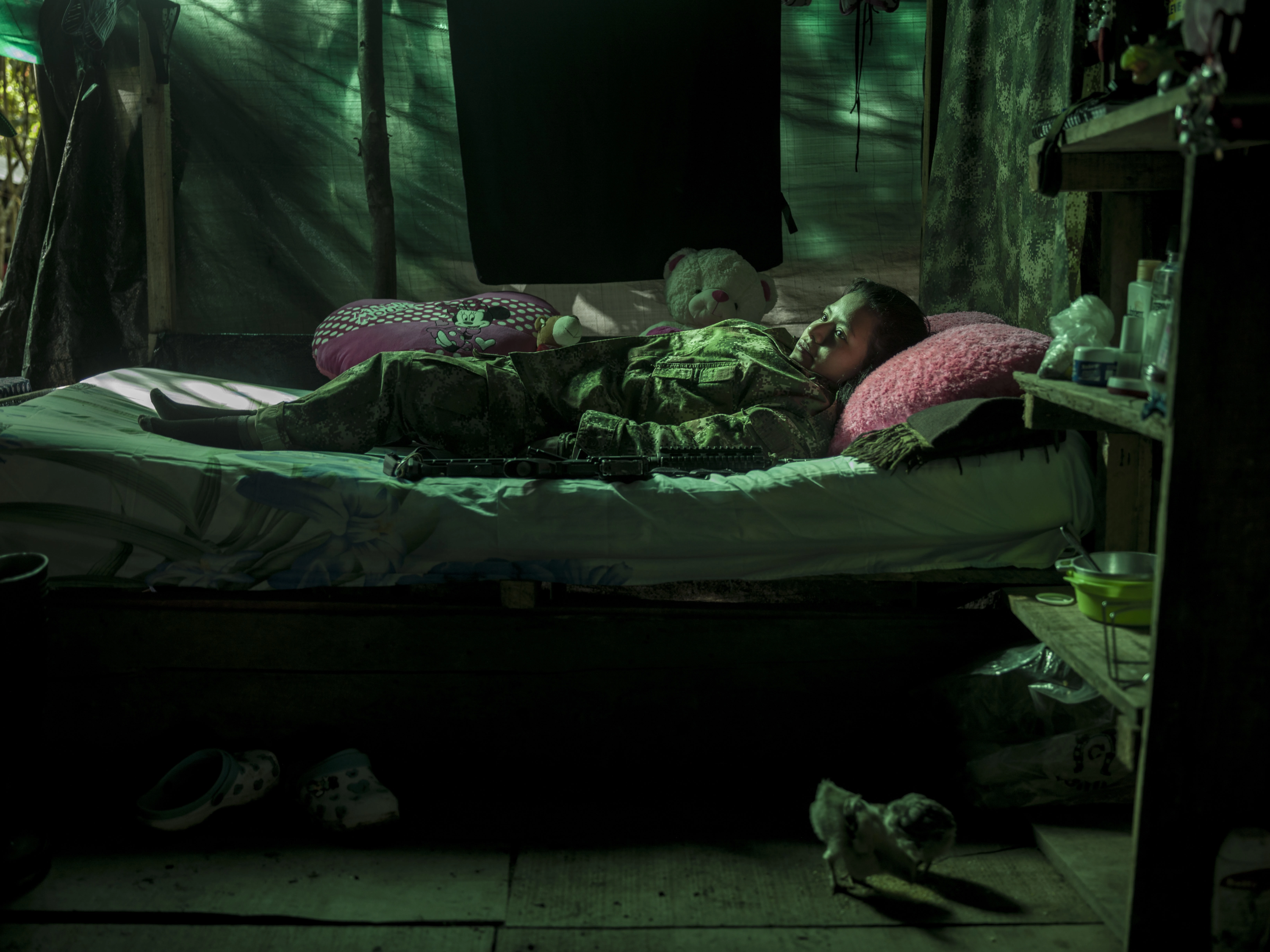 COLOMBIA. 2017. Andrea Cepeda, 23, joined the guerrilla 8 years ago when she was 16. "My father was also a Farc guerrilla, when I was 11 he was killed, after that my mother took all her children to Cali and we started working on a land as farmers. While we were working the Farc guerrillas where there most of the time and I was wondering all the time that I should join them along with my sister. So one day I made my decision and left the house. Since I was a small girl, when we would go to battle my commander did not want me not to be in the front line and my task was to take care of the other commanders in the back. All my belongings from these past 8 years can be packed into just one small backpack because we had to run away all the time and we didn't have time to pack and we always had to be ready. I lost my best friend in an attack, I wish she was here with me. I'm scared of my future, because of the paramilitary who want to kill us."