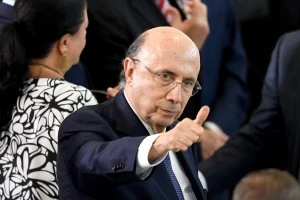 Brazilian Finance Minister Henrique Meirelles gives the thumb up during the swearing in ceremony of Brazilian new Minister of Justice Osmar Serraglio and new Minister of Foreign Affairs Aloysio Nunes Ferreira (out of frame) at Planalto Palace in Brasilia, on March 7, 2017.Serraglio replaces Alexandre de Moraes, who was appointed for the Supreme Court, and Nunes replaces Jose Serra, who stepped down citing health concerns. / AFP PHOTO / EVARISTO SA (Photo credit should read EVARISTO SA/AFP/Getty Images)