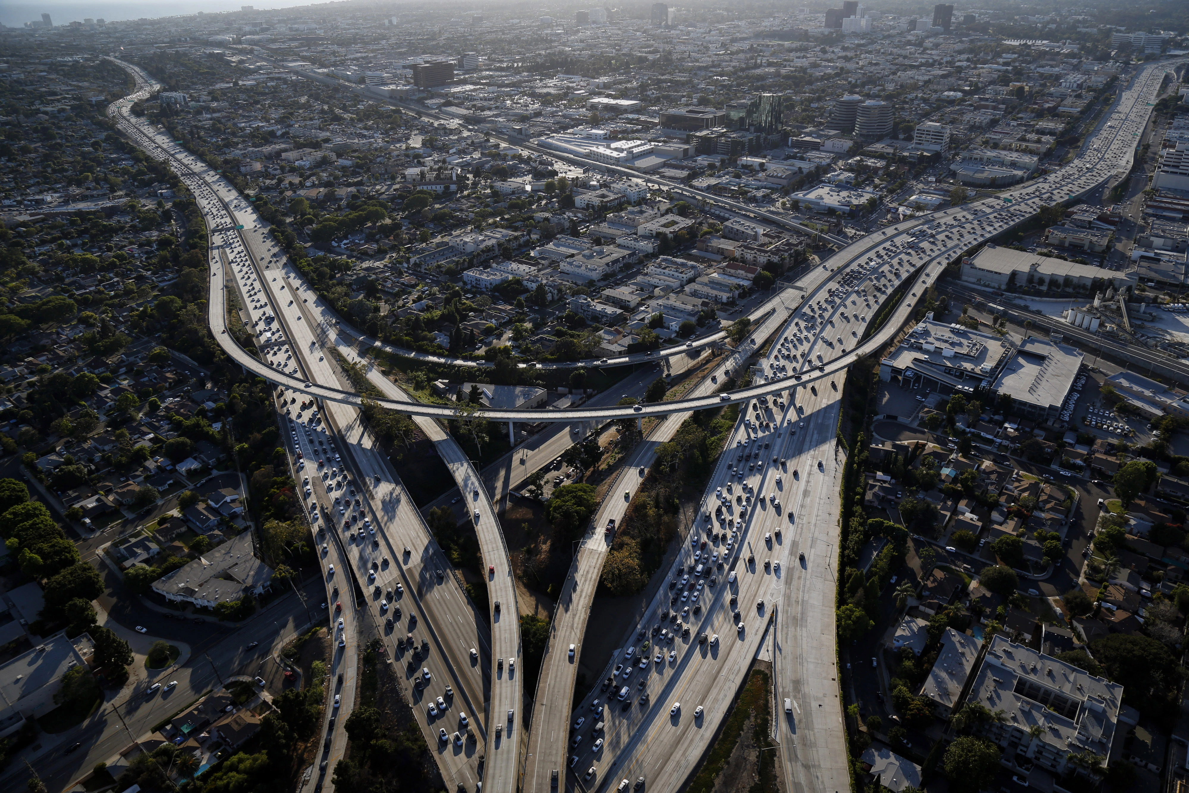 Vehicles sit in rush hour traffic between the Interstate 405 and 10 freeways in this aerial photograph taken over Los Angeles, California, U.S., on Friday, July 10, 2015. The greater Los Angeles region routinely tops the list for annual traffic statistics of metropolitan areas for such measures as total congestion delays and congestion delays per peak-period traveler. Photographer: Patrick T. Fallon/Bloomberg via Getty Images