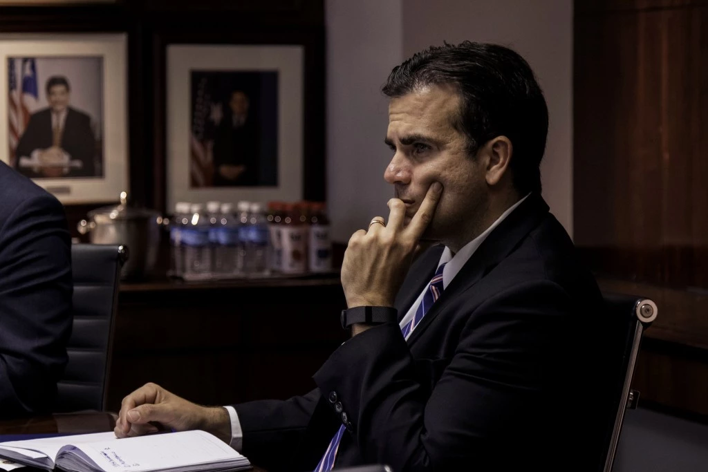 Ricardo Rossello, governor of Puerto Rico, listens during a meeting at Puerto Rico Industrial Development Company (PRIDCO) headquarters in San Juan, Puerto Rico, U.S., on Tuesday, March 28, 2017. Puerto Rico's economy has been contracting for a decade. Last year, almost 65,000 residents left the island, keeping pace with the previous two years, when the exodus reached the worst since at least the 1980s. Photographer: Alejandro Granadillo/Bloomberg via Getty Images