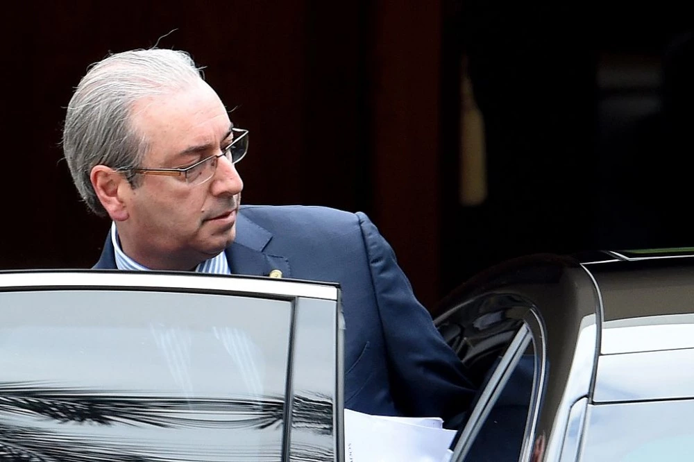 The president of the Brazilian chamber of deputies, Eduardo Cunha leaves the official residence on his way to the Congress in Brasilia on December 17, 2015. The Attorney General of the Republic, Rodrigo Janot, presented to the Federal Supreme Court (STF) a request for precautionary removal of Eduardo Cunha from the position of Congressman and Speaker of the House.  AFP PHOTO/EVARISTO SA / AFP / EVARISTO SA        (Photo credit should read EVARISTO SA/AFP/Getty Images)