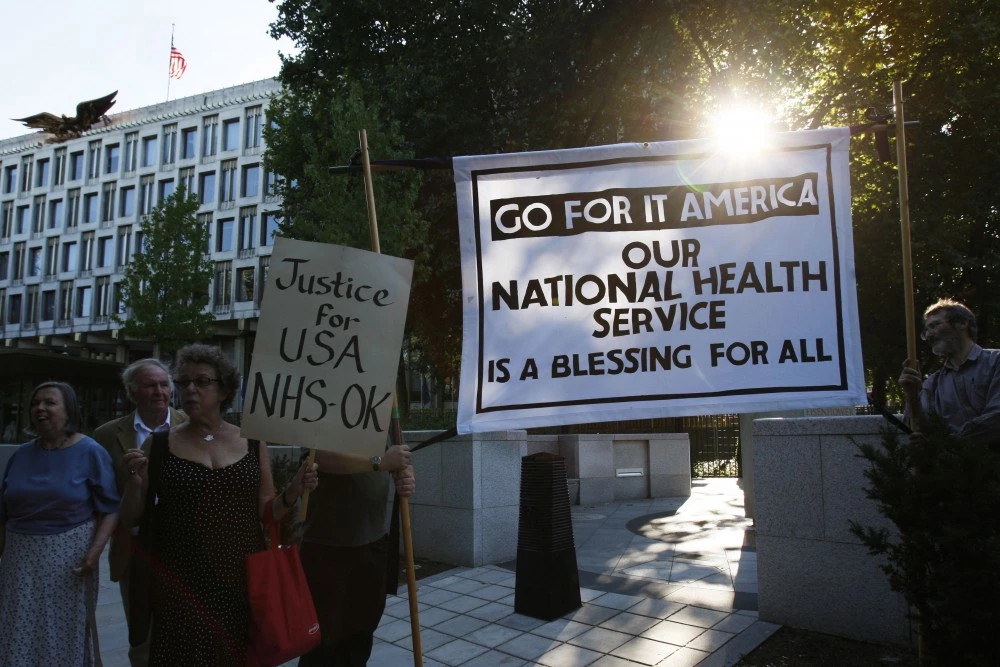 Supporters of Britain's National Health Service hold a banner reading 'Go for it America our National Health Service is a blessing for all' in a demonstration outside the U.S. Embassy in London, Wednesday, Aug. 19, 2009.  The demonstration is intended to send a message to the citizens of U.S. where President Barack Obama is trying to introduce a government run national health plan but the plan's opponents have been vociferous claiming the British National Health Service does not work. (AP Photo/Sang Tan)