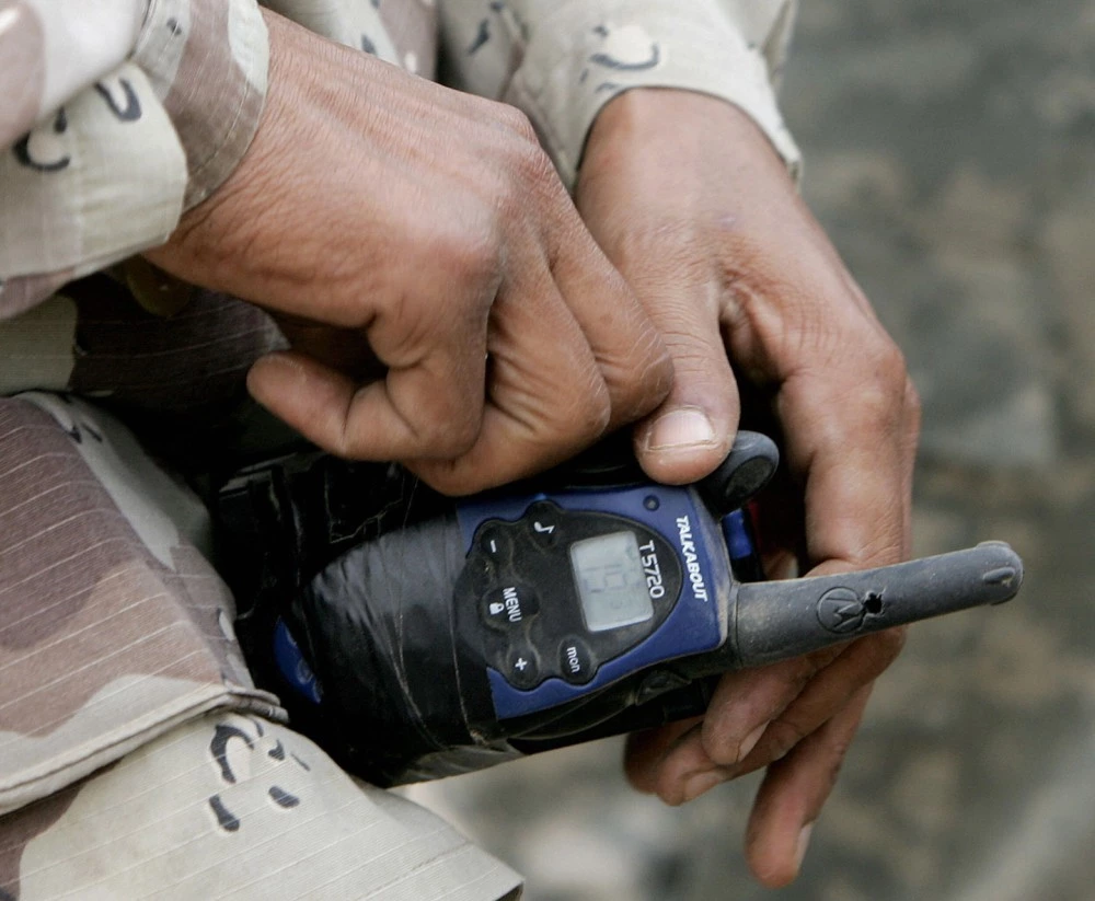 HAWIJAH, Iraq:  An Iraqi soldier checks the detonator on spot where an Improvised Explosive Device blew up as a convoy of the 1st battalion 327th infantry regiment was driving along a country road on the outskirts of the northern city of Hawijah,  25 December 2005. A US soldier was killed by a roadside bomb on Christmas day, in Baghdad, the US military said. AFP PHOTO / Filippo MONTEFORTE  (Photo credit should read FILIPPO MONTEFORTE/AFP/Getty Images)