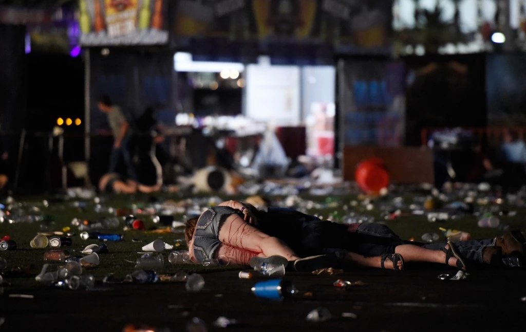 LAS VEGAS, NV - OCTOBER 01: (EDITORS NOTE: Image contains graphic content.) A person lies on the ground covered with blood at the Route 91 Harvest country music festival after apparent gun fire was heard on October 1, 2017 in Las Vegas, Nevada. There are reports of an active shooter around the Mandalay Bay Resort and Casino.  (Photo by David Becker/Getty Images)