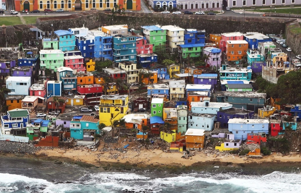 SAN JUAN, PUERTO RICO - OCTOBER 18:  The damaged La Perla neighborhood is viewed from the air during recovery efforts four weeks after Hurricane Maria struck on October 18, 2017 in-flight over Puerto Rico.  Puerto Rico is suffering shortages of food and water in areas with only 19.10 percent of grid electricity restored. Puerto Rico experienced widespread damage including most of the electrical, gas and water grid as well as agriculture after Hurricane Maria, a category 4 hurricane, swept through.  (Photo by Mario Tama/Getty Images)