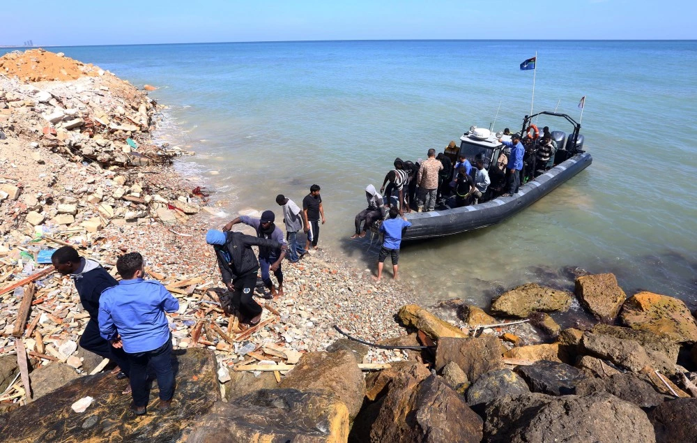 TOPSHOT - Illegal migrants from Africa arrive on shore after being rescued by Libyan coast guards rescued at sea, off the coastal town of Tajoura, 15 kilometres east of the capital Tripoli on May 23, 2017. / AFP PHOTO / MAHMUD TURKIA        (Photo credit should read MAHMUD TURKIA/AFP/Getty Images)