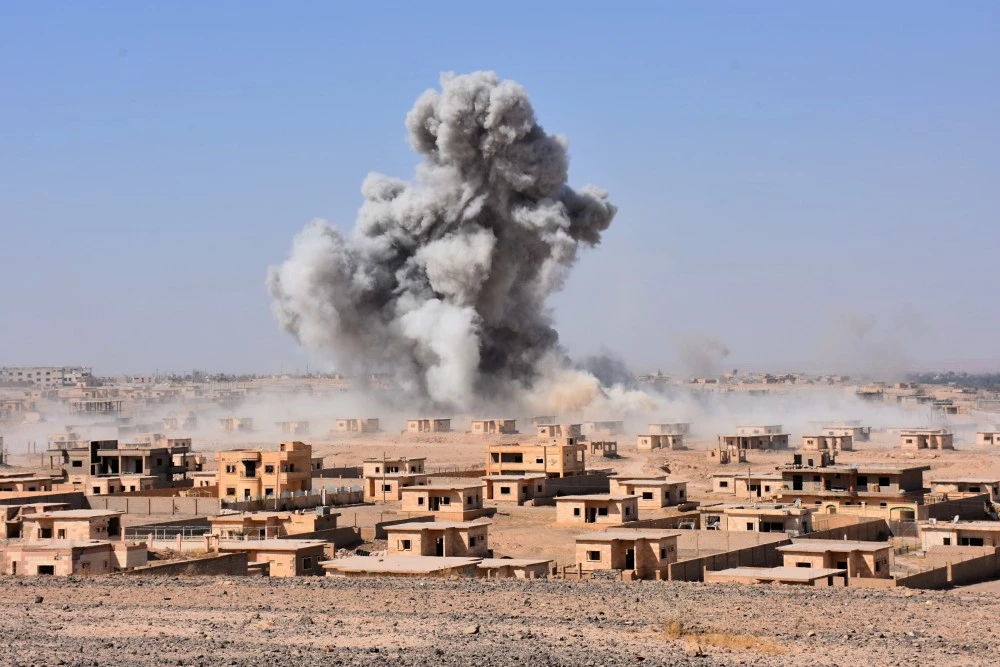 Smoke rises from buildings in the area of Bughayliyah, on the northern outskirts of Deir Ezzor on September 13, 2017, as Syrian forces advance during their ongoing battle against the Islamic State (IS) group. After breaking an Islamic State group blockade, Syria's army is seeking to encircle the remaining jihadist-held parts of Deir Ezzor city, a military source. / AFP PHOTO / George OURFALIAN (Photo credit should read GEORGE OURFALIAN/AFP/Getty Images)