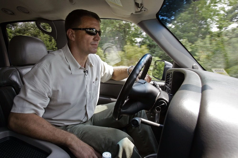 Erik Prince, Founder and CEO of Blackwater Worldwide drives through campus in Moyock, N.C., Monday, July 21, 2008. Prince, along with another former Navy SEAL, turned to the swamps of eastern North Carolina, where he could train SEALS based at Virginia Beach and build a business among law enforcement and military, believing all lacked a one-stop training site. (AP Photo/Gerry Broome)