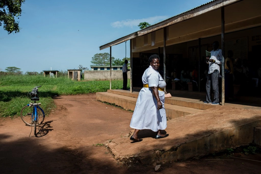 Filder Akello, a nurse midwife, enters another health facility on March 27, 2018 in Bobi, Uganda.