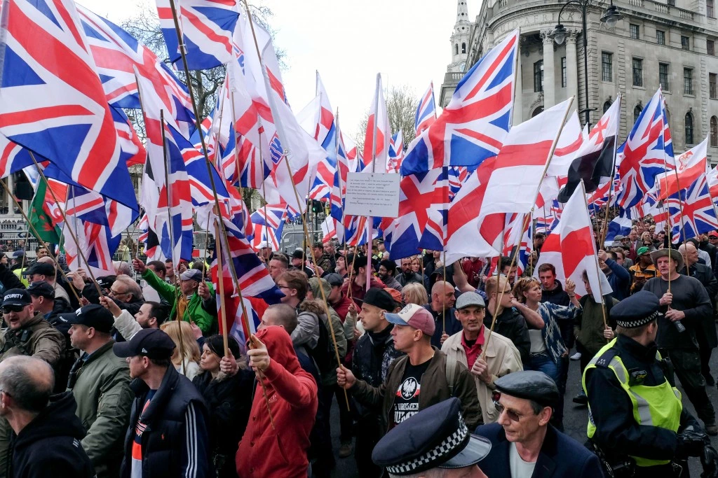 Protesters hold placards and British Union Jack flags during a protest titled 'London march against terrorism' in response to the March 22 Westminster terror attack on April 1, 2017 in London, England. The march has been organised by far-right groups English Defence League and Britain First, which also sees a counter-protest held by group 'Unite Against Fascism'. (Photo by Jay Shaw Baker/NurPhoto) *** Please Use Credit from Credit Field ***(Sipa via AP Images)
