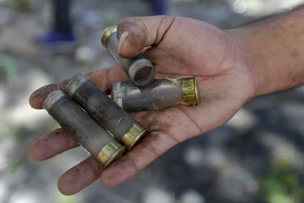 A protester shows spent rubber bullet casings shot by police during a general strike against a pension reform measure, outside Congress in Buenos Aires, Argentina, Monday, Dec. 18, 2017. Union leaders complain the legislation, which already passed in the Senate, would cut pension and retirement payments as well as aid for some of poor families. (AP Photo/Victor R. Caivano)
