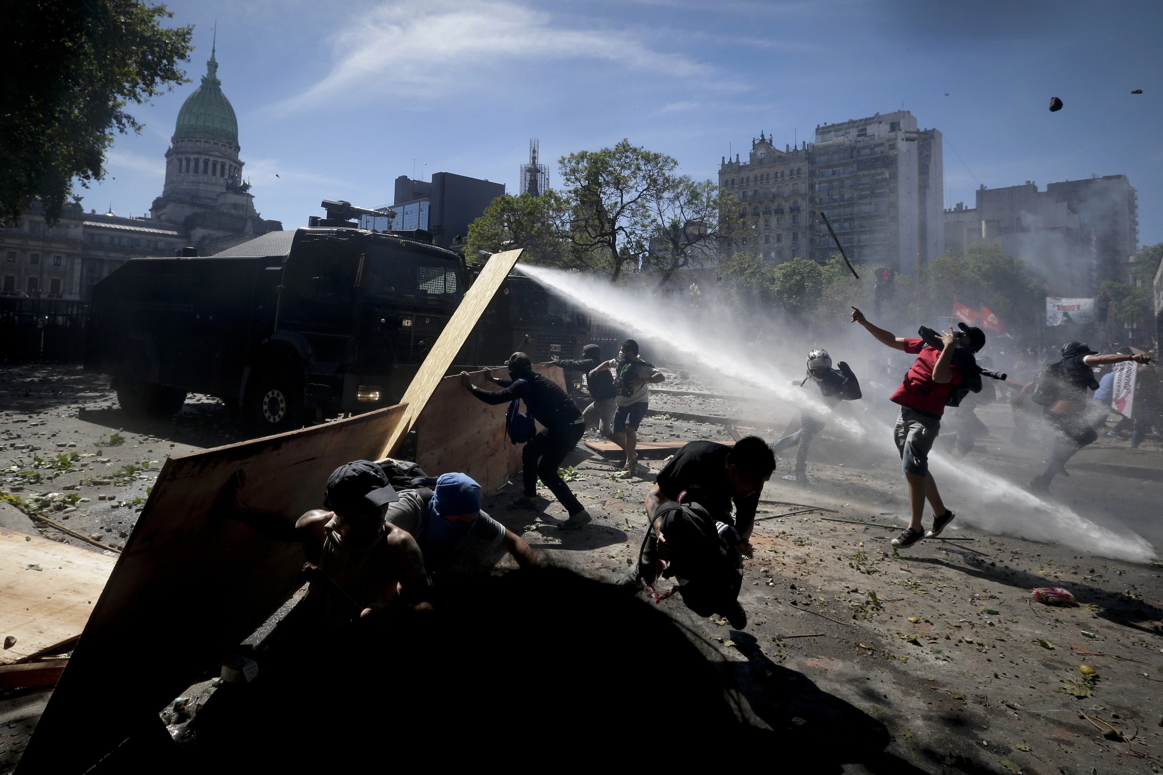 Protesters clash with police during a general strike against a pension reform measure, outside Congress in Buenos Aires, Argentina, Monday, Dec. 18, 2017. Union leaders complain the legislation, which already passed in the Senate, would cut pension and retirement payments as well as aid for some of poor families. (AP Photo/Victor R. Caivano)