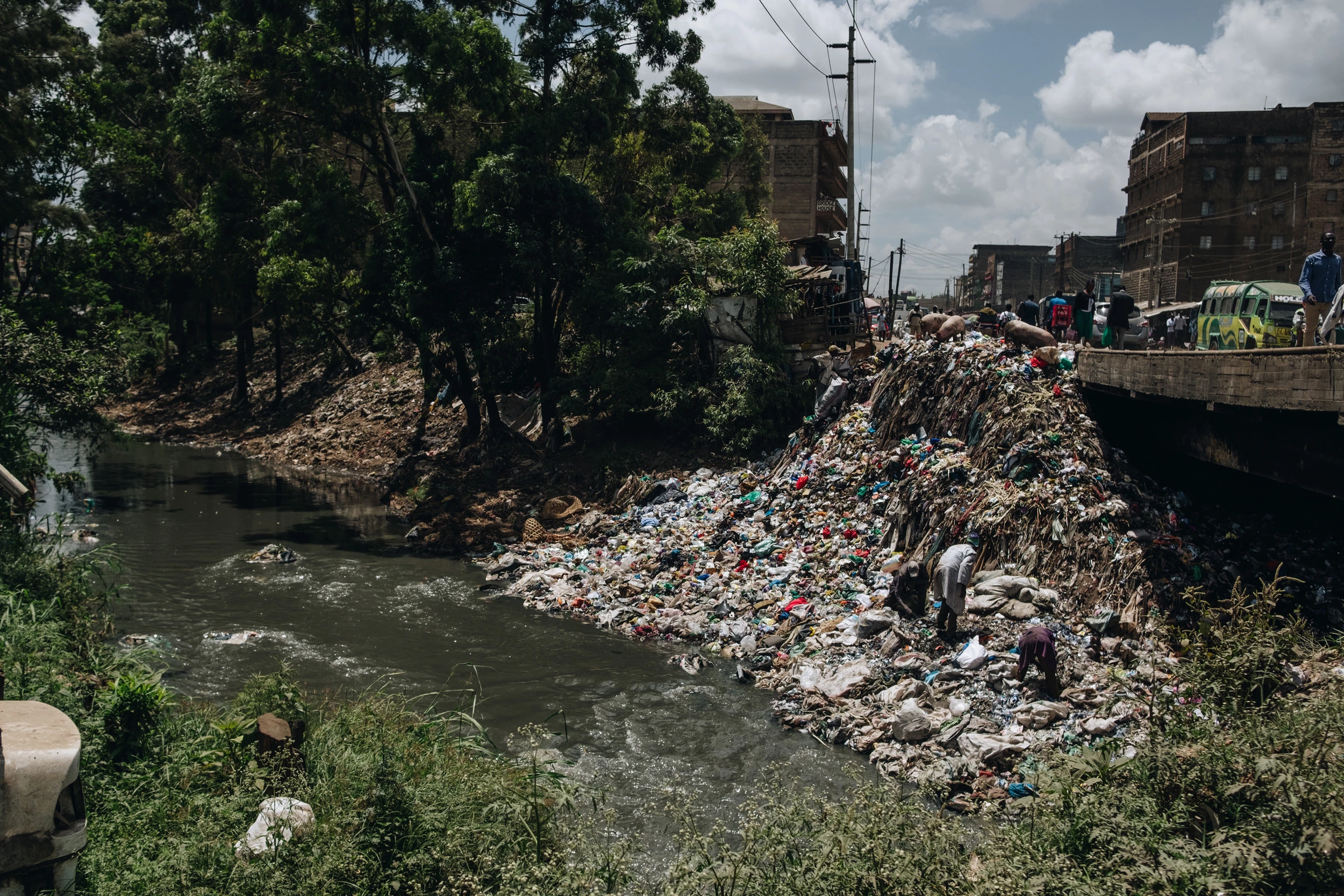 Plastic waste covers the banks of the Nairobi River on Feb. 15, 2020. Though the river is polluted, it is used by residents of low-income settlements as a source of water for cleaning, bathing, and watering crops.
