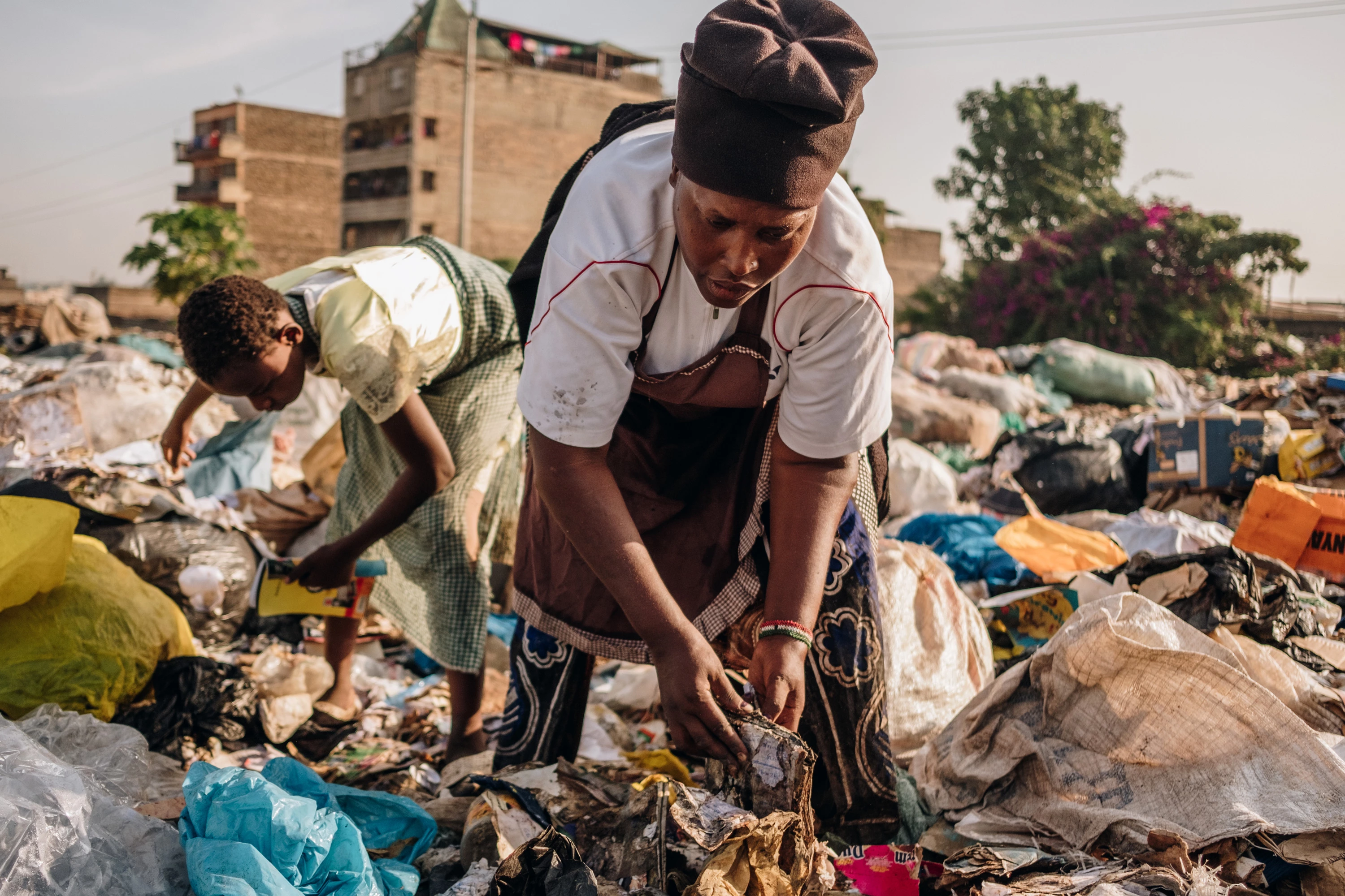 Miriam Nyambura and her 11-year-old niece, Rosemary, collect discarded cardboard boxes, paper, and plastic bottles at the Dandora dump on Feb. 29, 2020. Miriam picks an average of 20kgs of waste each day.