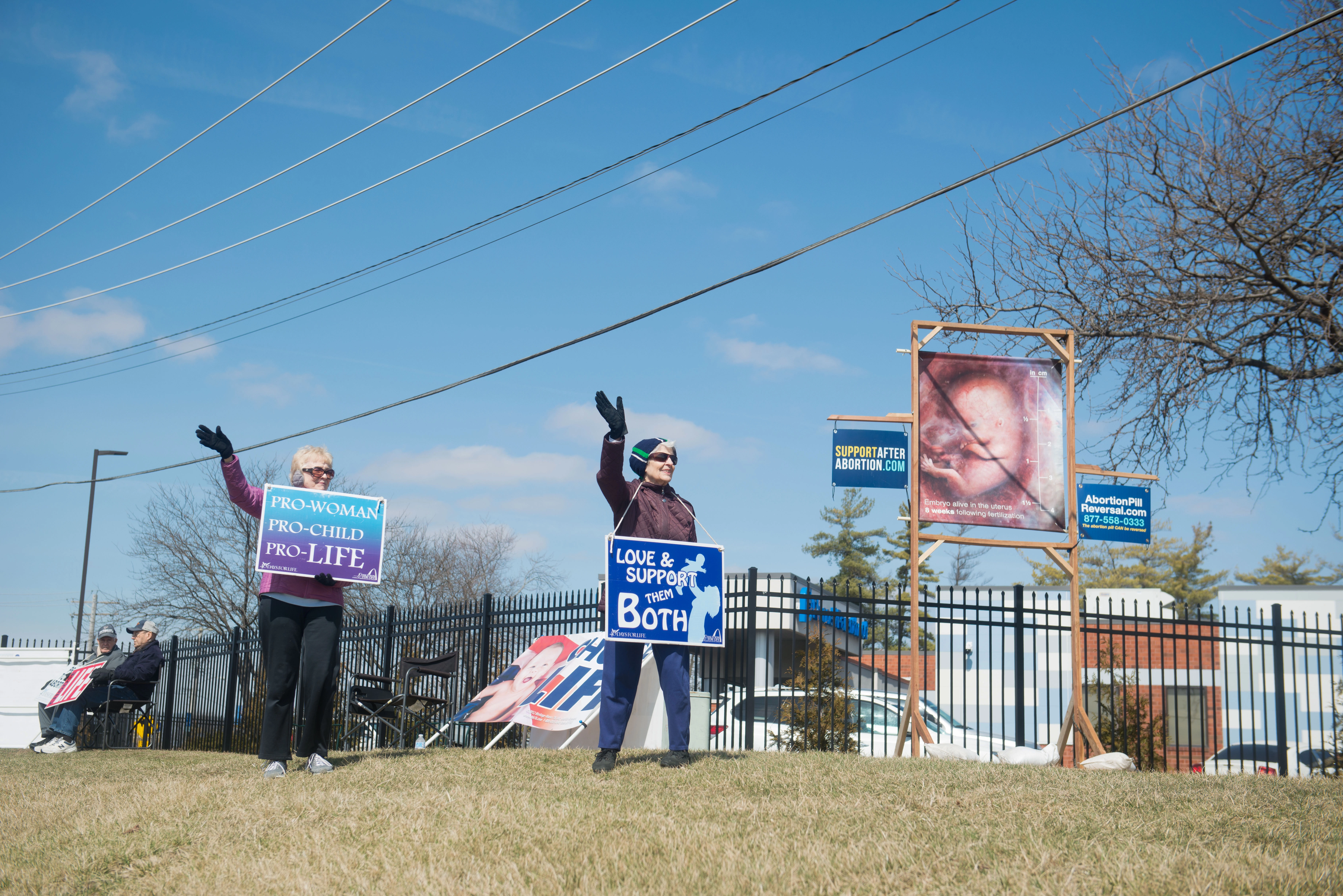 40 Days for Life protestors wave at passing cars outside the  Planned Parenthood clinic in Fairview Heights, Ill., on Tuesday, March 8, 2022.  40 Days for Life is a religious anti-abortion movement that holds protests and prayer vigils outside abortion clinics across the US during Lent. (Photo by Neeta Satam for The Washington Post via Getty Images)